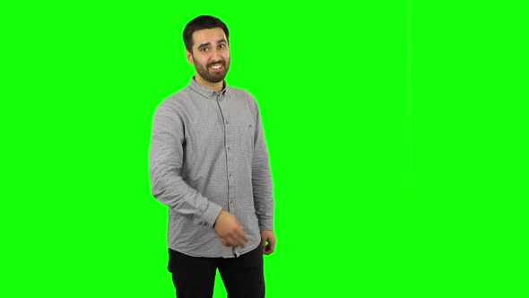 Brunette Guy Is Waving Hand and Showing Gesture Come Here. Green Screen