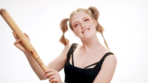 Young Beautiful Girl Smiling Dancing with Bat Over White Background