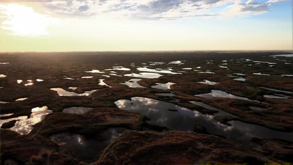 Aerial pan right of beautiful sunrise reflections, Potholes, Washington