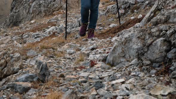 Closeup of Female Traveler Crossing Rocky Terrain