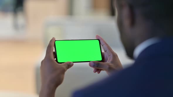 African Man Watching Smartphone with Chroma Screen