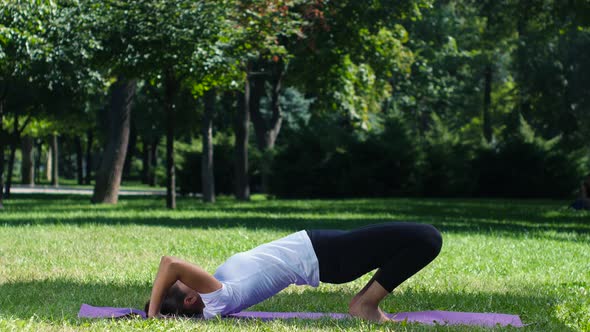 Woman Practicing Yoga in the Park