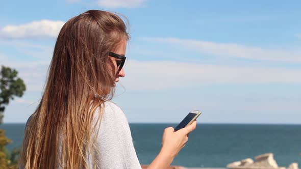 Girl Use Phone On Sea Background