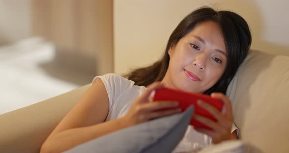 Woman work on cellphone at night