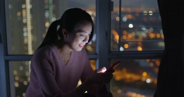 Woman look at mobile phone in the evening