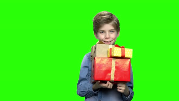 Portrait of Little Boy in Denim Jacket with Gift Boxes