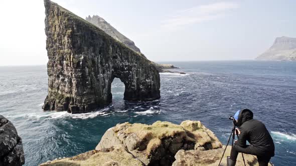 Male Photographer Behind a Tripod and Camera Capturing the Beautiful Scenery