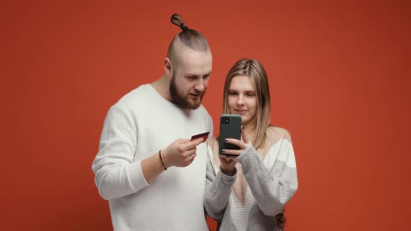 Happy Couple Woman and Man Buying Online Using Smartphone and Credit Card