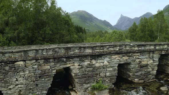 Bridge Over Flowing Waters Of Gudbrandsjuvet In Andalsnes, Norway. drone ascend
