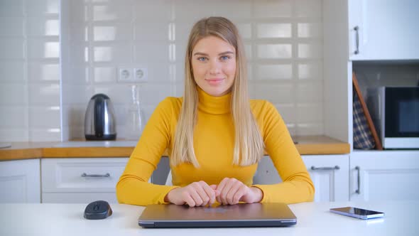 Happy blonde female working freelance from home during lockdown in 4k footage