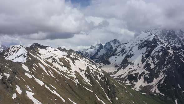 Flight above snowcapped mountains near Elbrus