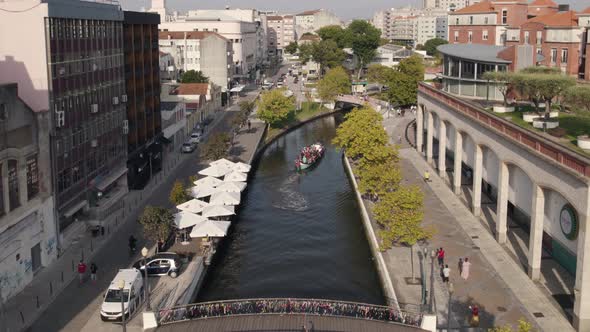 Moliceiros, tradicional boasts, with tourists enjoying the canals of Ria de Aveiro, Portugal