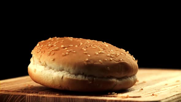 A Burger Bun Falls on the Cutting Board