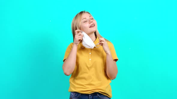 The Young Woman, Happy That She Escaped the Pandemic, Removes Her Surgical Mask From Her Face