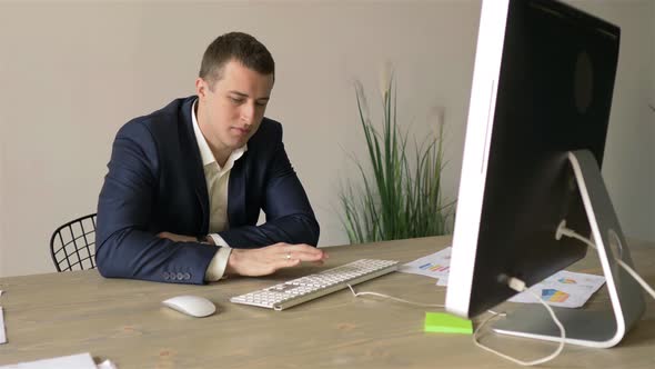 middle-aged manager working at the computer