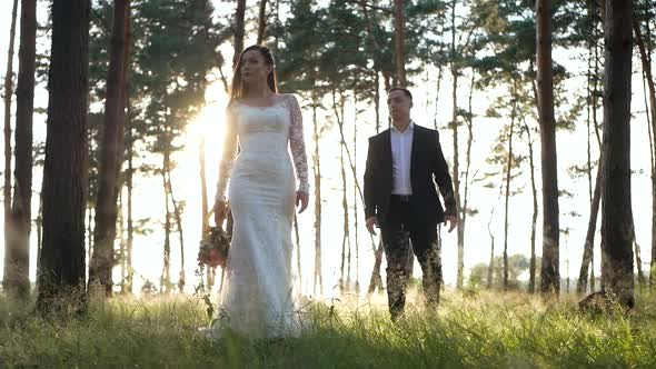 Stylish and tender couple in love - the bride and groom in the park