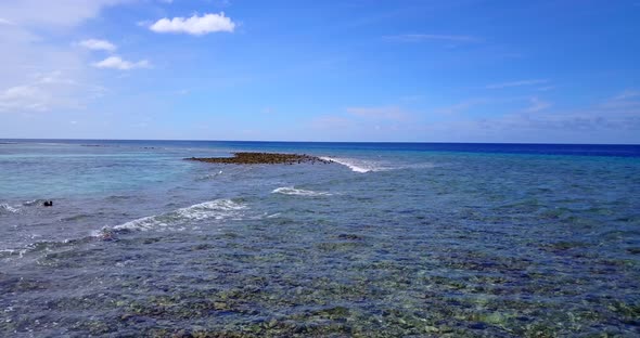 Tropical birds eye clean view of a sunshine white sandy paradise beach and blue water background