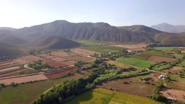 Aerial travel drone view of farms and farming.