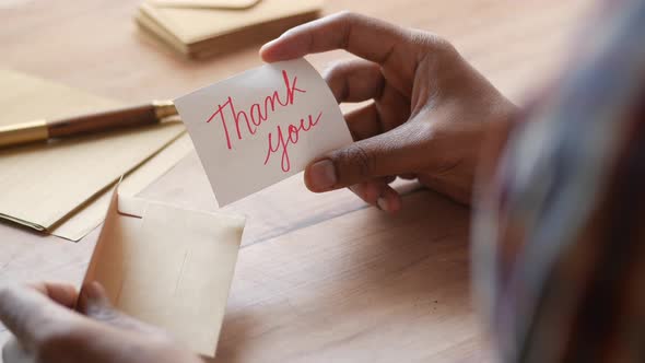 Close Up of Man Hand Reading a Thank you Letter