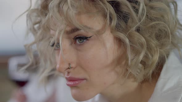 Headshot Portrait of Sad Beautiful Caucasian Pierced Woman Thinking
