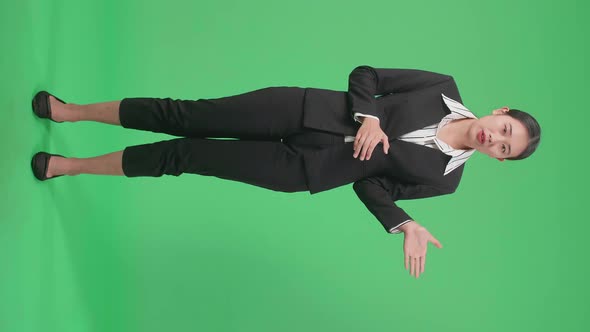 Full Body Of Asian Businesswoman Pointing On Something And Talking On The Green Screen Background