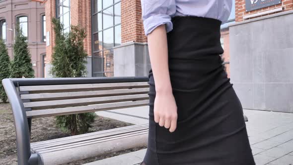 Woman Leaving for Office after Relaxing on Bench Outdoor