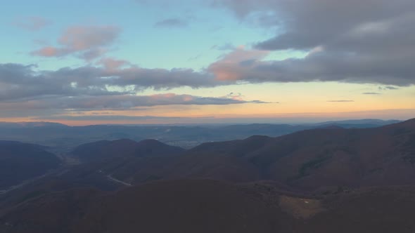 Beautiful colorful sunset clouds above hills