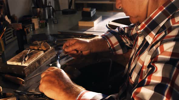 Goldsmith using hand piece machine