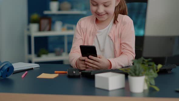 Cheerful Child Looking at Smartphone with Touch Screen