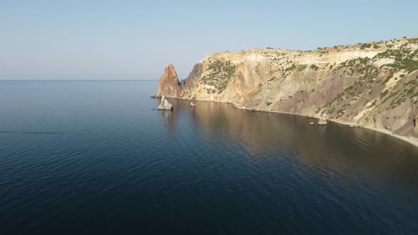 Aerial View From Above on Calm Azure Sea and Volcanic Rocky Shores