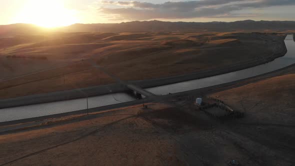 Incredible sunset aerial of California irrigation canal on the road to Los Angeles, California.  Agr