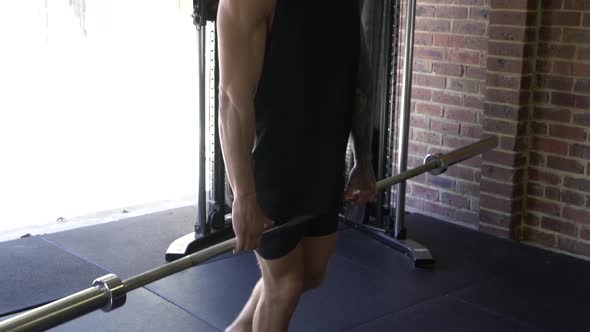 Muscly man in home gym exercising deadlift balance single leg workout