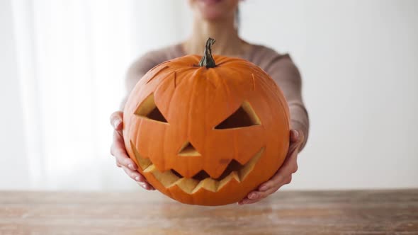 Close Up of Woman with Halloween Pumpkin at Home 