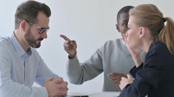 Angry Business People Scolding Businessman in Office