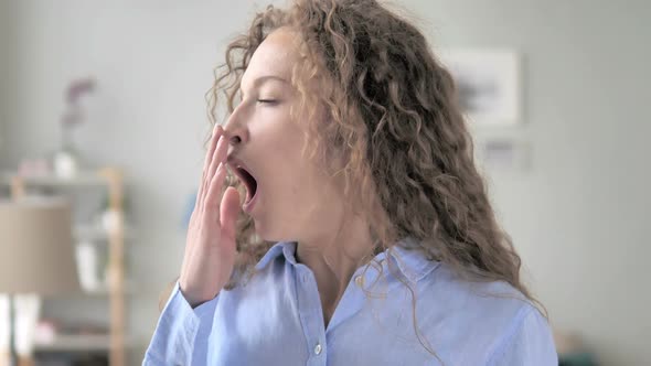 Portrait of Tired Curly Hair Woman Yawning