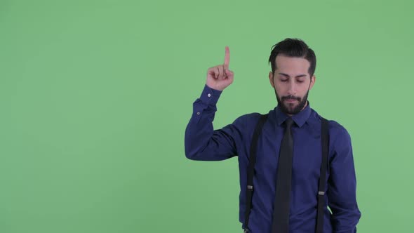 Stressed Young Bearded Persian Businessman Pointing Up