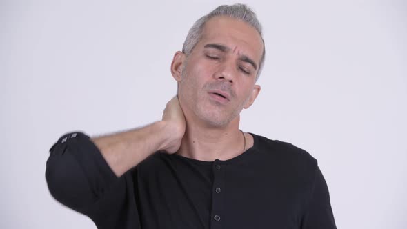 Stressed Persian Man Having Neck Pain Against White Background