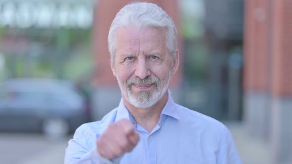 Outdoor Old Man Pointing Finger at Camera