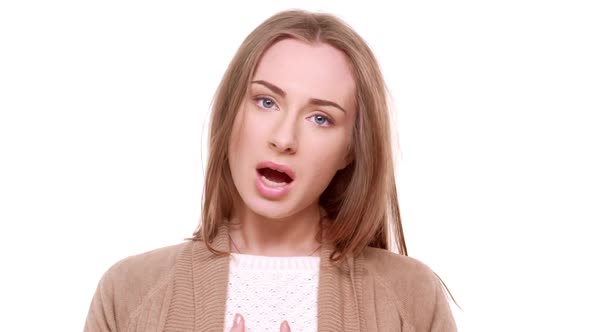 Young Cute Caucasian Female Playing Making Faces Smiling Waving Head Standing on White Background in