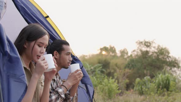 Asian tourists camping and drinking coffee in morning