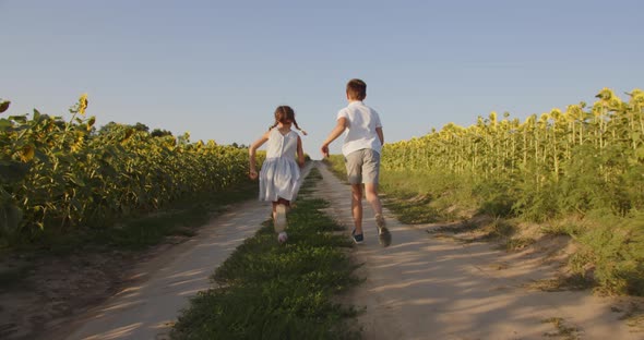 Children Run Along A Field Path