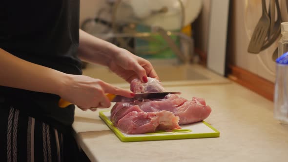 Woman Cuts Meat Closeup