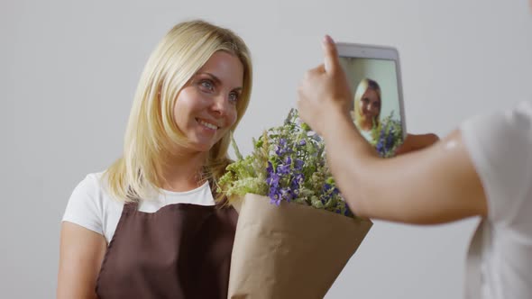 Lovely Florist Being Filmed by Colleague