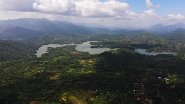 Tropical Landscape Agricultural Land with Plantings Against a Background of Mountains and Blue Sky