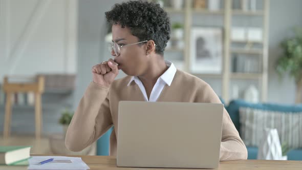 Working African Girl Coughing While Using Laptop