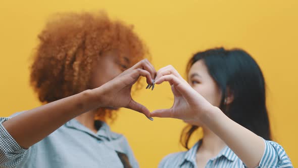 Multiracian Homosexual Relationship Concept. African American Black and Asian Woman Making Hearts