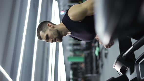 Sport Man Running on Treadmill Machine While Cardio Training in Gym Club