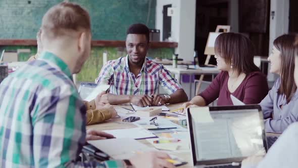 Creative Business Team Meeting in Modern Office. Mixed Race Group of Young People Discussing