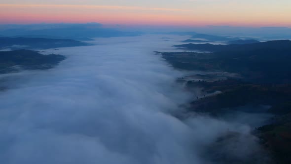 4K Aerial video Beautiful sunrise above dense clouds and fog in the morning