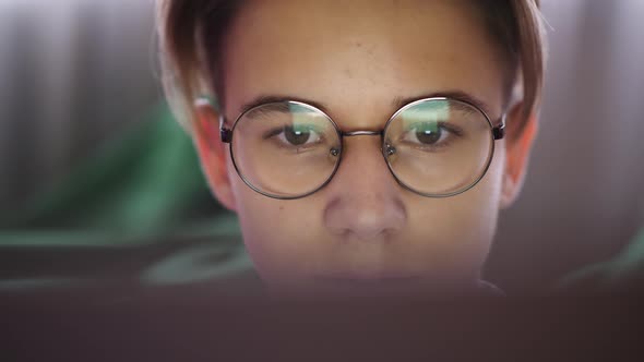 Teenage Boy Looking at Laptop Screen, Close-up
